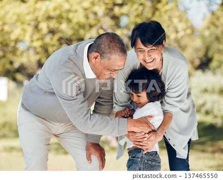 Happy, hug and grandparents with child in park for playing, love and support. Care, smile and freedom with family and embrace on nature path for peace, summer vacation and happiness together 137465550