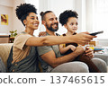 Interracial parents, child and watching tv on sofa, remote and choice for video, movie or show in living room. Father, mother and kid on lounge couch, comedy and streaming subscription in family home 137465615