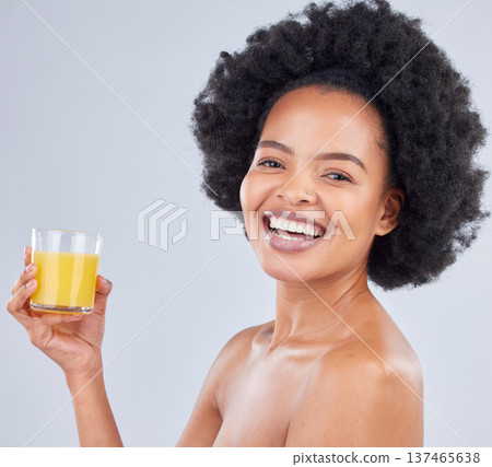 Woman, portrait and glass of orange juice in studio for vitamin c benefits on gray background. Face, happy african model and drink citrus fruit smoothie for healthy nutrition, diet and natural beauty Woman, portrait and glass of orange juice in studio for vitamin c benefits on gray background. Face, happy african model and drink citrus fruit smoothie for healthy nutrition, diet and natural beauty 137465638
