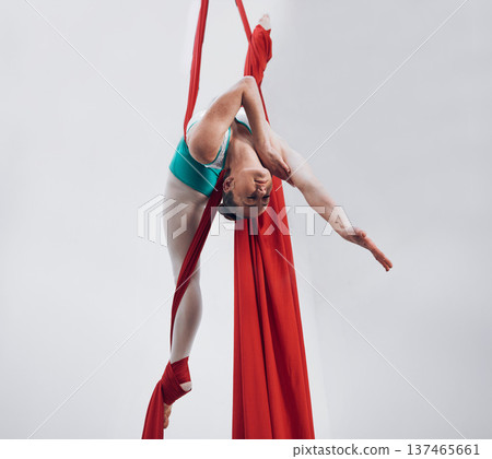 Aerial, woman gymnast and strong performance with stretching, flexibility and athlete with white background. Workout, exercise and gymnastics with balance, art and dance with acrobat competition 137465661