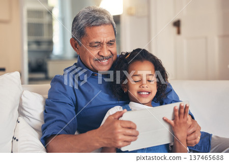 Old man, kid and tablet, cartoon and relax together on sofa, bonding with online streaming and connection. Love, care and grandfather with child and technology, subscription and watch video or film Old man, kid and tablet, cartoon and relax together on sofa, bonding with online streaming and connection. Love, care and grandfather with child and technology, subscription and watch video or film 137465688