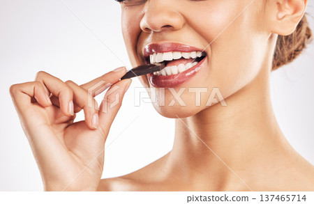 Woman, chocolate and mouth for eating, studio and healthy with nutrition, diet and bite by white background. Girl, model and cacao for wellness, detox or cosmetics with detox, teeth or antioxidants Woman, chocolate and mouth for eating, studio and healthy with nutrition, diet and bite by white background. Girl, model and cacao for wellness, detox or cosmetics with detox, teeth or antioxidants 137465714