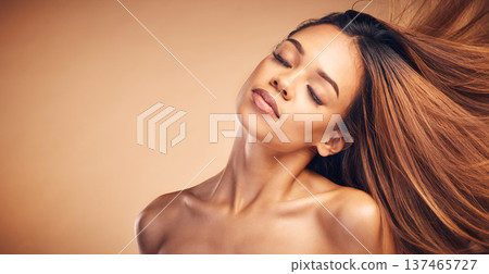 Mockup, beauty and hair with a natural woman in studio on a brown background for keratin treatment. Face, space and shampoo with a confident young model at the salon for growth or aesthetic haircare 137465727