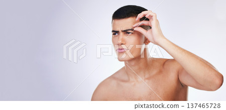 Man, grooming and clean skincare with facial and beauty treatment for skin and wellness in studio. Male model, dermatology and hair removal tool of eyebrows with grey background and mockup space Man, grooming and clean skincare with facial and beauty treatment for skin and wellness in studio. Male model, dermatology and hair removal tool of eyebrows with grey background and mockup space 137465728