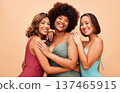 Diversity, bikini and portrait of women hug together happy for beach vacation isolated in a studio brown background. Smile, beauty and happy friends ready for summer holiday in swimsuit fashion 137465915