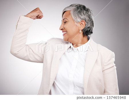 Strong, smile and mature businesswoman in a studio with strength, feminism or confidence gesture. Happy, empowerment and female model from Mexico flexing her arm muscles for emoji by gray background. 137465948