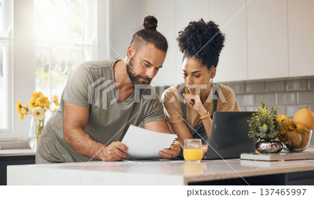 Interracial couple, laptop in kitchen and insurance paperwork, budget and finance with life and marriage. Partner, people at home and reading document with policy, taxes and bills with mortgage Interracial couple, laptop in kitchen and insurance paperwork, budget and finance with life and marriage. Partner, people at home and reading document with policy, taxes and bills with mortgage 137465997