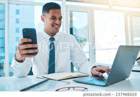 Laptop, phone and business man typing in office, multitask and working on project. Computer, smartphone and happy consultant on internet, networking on email app and research information on website Laptop, phone and business man typing in office, multitask and working on project. Computer, smartphone and happy consultant on internet, networking on email app and research information on website 137466020