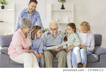 Happy loving big family, three generation people gathering watching photo album, senior grandparents Happy loving big family, three generation people gathering watching photo album, senior grandparents 137466113