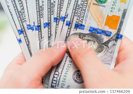 Man counting US dollar banknotes. Business finance, salary, income calculation, budgeting and economic control concept. Man counting US dollar banknotes. Business finance, salary, income calculation, budgeting and economic control concept. 137466209
