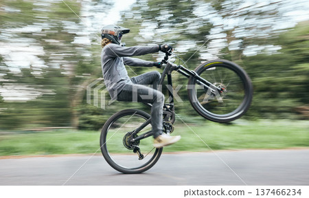 Bike, man and balance on wheel in nature for competition, challenge and adventure of motion in road. Cycling, sports race and fast action on bicycle for performance, energy with power, speed and risk 137466234