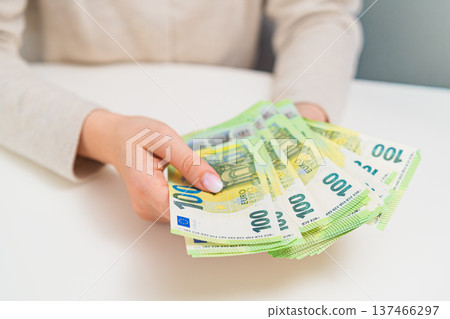 Close up of woman counting euro bills. Concept of budgeting, salary income, personal finance, savings and household money management. Close up of woman counting euro bills. Concept of budgeting, salary income, personal finance, savings and household money management. 137466297