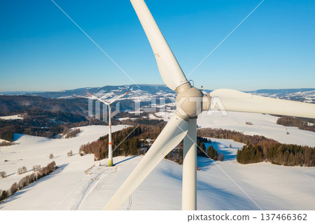 Wind turbine in a snow covered field during winter. Concept of reliable power supply and renewable energy. Wind turbine in a snow covered field during winter. Concept of reliable power supply and renewable energy. 137466362