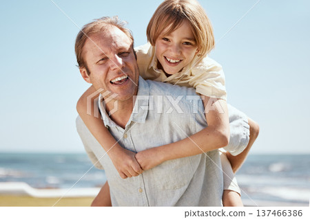Happy father, child and piggyback on beach in family bonding, outdoor weekend or holiday on summer break. Portrait of dad and son in hug, love or care for childhood or enjoying day together at ocean Happy father, child and piggyback on beach in family bonding, outdoor weekend or holiday on summer break. Portrait of dad and son in hug, love or care for childhood or enjoying day together at ocean 137466386