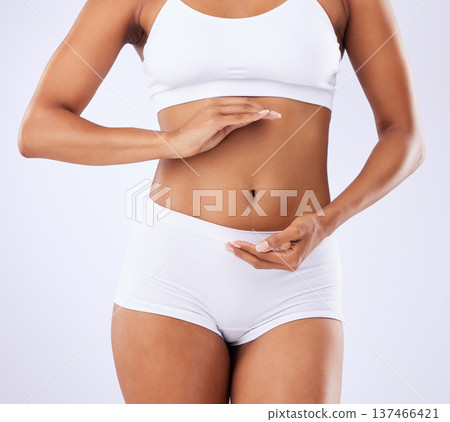 Stomach, health and woman in studio with hands for healthy body, wellness and nutrition. Fitness, lose weight and closeup of person on white background in underwear for diet, detox and abdomen care Stomach, health and woman in studio with hands for healthy body, wellness and nutrition. Fitness, lose weight and closeup of person on white background in underwear for diet, detox and abdomen care 137466421