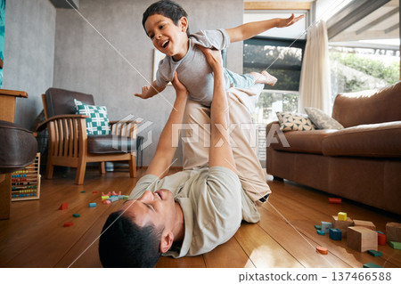 Child, father and airplane games in home on living room floor for support, happy together and crazy fun. Dad, boy and excited kid flying for freedom, fantasy and playing with balance, care and energy 137466588