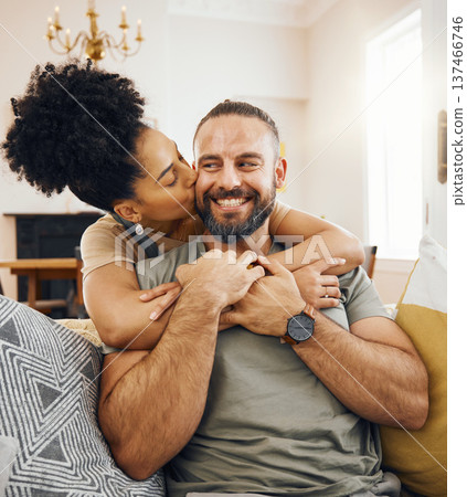 Happy couple, hug and kiss on sofa in home, living room or bonding in apartment with love in marriage or relationship. Man, smile and woman embrace or support partner on couch or relax together 137466746