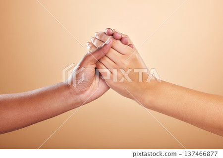 Beauty, skincare and support with women holding hands in studio on a beige background for community or motivation. Trust, natural and cosmetics with model friends connected in unity or solidarity 137466877
