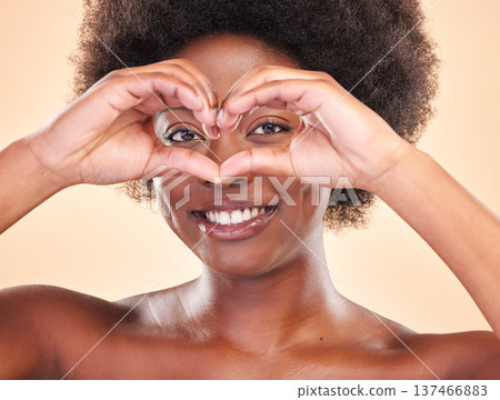 Smile, portrait and a black woman with heart hands on a studio background for love or support. Happy, emoji and face of African girl or model with a sign or gesture for care or kindness on a backdrop Smile, portrait and a black woman with heart hands on a studio background for love or support. Happy, emoji and face of African girl or model with a sign or gesture for care or kindness on a backdrop 137466883