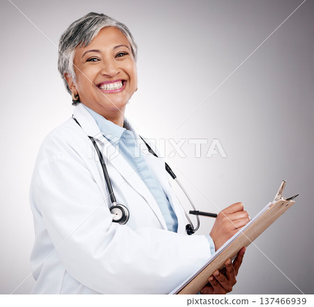 Woman, portrait and doctor writing on clipboard in studio for notes, healthcare administration or info. Happy mature surgeon with report of insurance checklist, documents or script on gray background 137466939