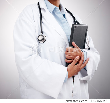 Tablet, technology and hands of doctor in studio for healthcare services, telehealth support and help. Closeup of medical worker, digital connection and consulting clinic research on gray background 137466943