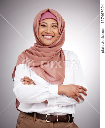 Muslim, arms crossed and portrait and woman in studio with happiness, style and positive attitude. Hijab, islam and islamic fashion with a person on grey background for business and confidence Muslim, arms crossed and portrait and woman in studio with happiness, style and positive attitude. Hijab, islam and islamic fashion with a person on grey background for business and confidence 137467004