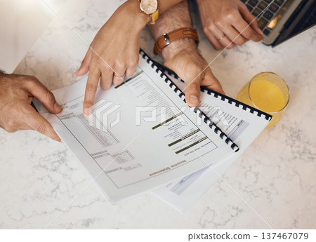 Hands, documents and a couple in the kitchen to budget for finance, investment or savings in a home from above. Paper, insurance or planning with a husband and wife reading information for accounting 137467079