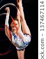 Woman, portrait and happy for ribbon gymnastics, sports performance or competition on black background. Flexible athlete, dancer and smile for agile showcase, talent and rhythmic contest in studio 137467114