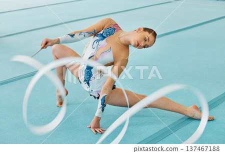 Woman, ribbon gymnastics and action for performance, sports competition and solo concert. Flexible dancer, rhythm and creative training of athlete with talent, energy and agile skill in contest arena 137467188