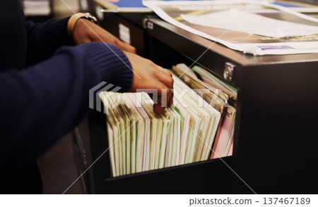 File cabinet, legal documents and person hands with management of tax report at office. Accountant, worker and notes in a workplace for corporate audit and paperwork documentation for debt books File cabinet, legal documents and person hands with management of tax report at office. Accountant, worker and notes in a workplace for corporate audit and paperwork documentation for debt books 137467189