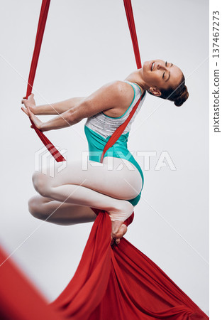 Gymnastics, performance and gymnast in sports competition for professional fitness challenge or dancing. Professional, healthy and woman with balance on silk isolated in a studio white background Gymnastics, performance and gymnast in sports competition for professional fitness challenge or dancing. Professional, healthy and woman with balance on silk isolated in a studio white background 137467273