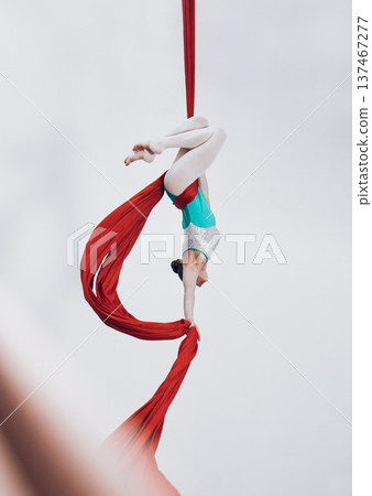 Aerial, woman gymnast and ribbon for sport performance with flexibility and athlete with white background. Workout, exercise and gymnastics with balance, art and dance with acrobat competition 137467277