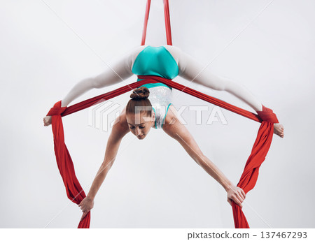Gymnast, woman acrobat with performance and talent, sports and art with athlete on white background. Gymnastics, training and exercise with creativity, fitness with fabric and competition in studio 137467293