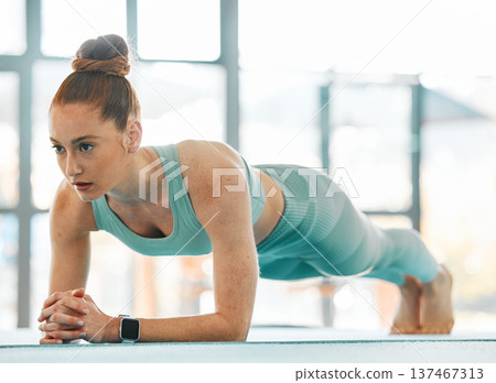 Workout, woman and serious for plank exercise in gym for strong core, training and balance of fitness. Athlete, active and control body on elbow for push up, sports challenge or muscle power on floor Workout, woman and serious for plank exercise in gym for strong core, training and balance of fitness. Athlete, active and control body on elbow for push up, sports challenge or muscle power on floor 137467313