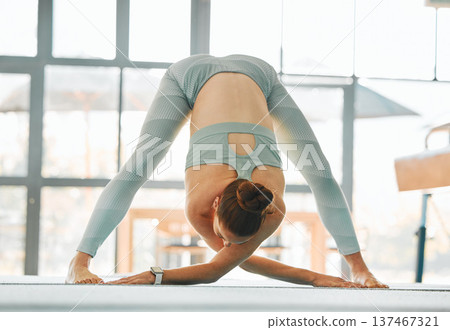 Sports, woman or gymnast stretching body or ready to start gymnastics performance in training. Fitness, wellness or flexible girl athlete in warm up for workout, practice or exercise in Texas, USA 137467321