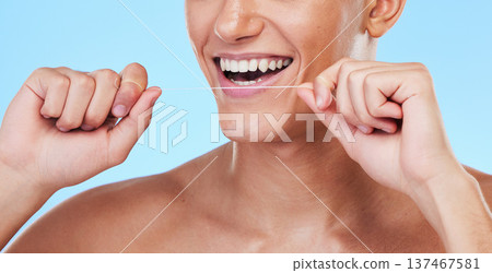Happy man, dental floss and cleaning teeth in oral hygiene or grooming against a blue studio background. Closeup of male person with big smile in flossing, tooth whitening or gum and mouth care Happy man, dental floss and cleaning teeth in oral hygiene or grooming against a blue studio background. Closeup of male person with big smile in flossing, tooth whitening or gum and mouth care 137467581