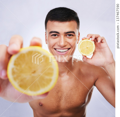 Beauty, lemon and offer with portrait of man in studio for health, detox and cosmetics. Vitamin c, nutrition and summer with face of person and fruit on white background for self care and skincare Beauty, lemon and offer with portrait of man in studio for health, detox and cosmetics. Vitamin c, nutrition and summer with face of person and fruit on white background for self care and skincare 137467590