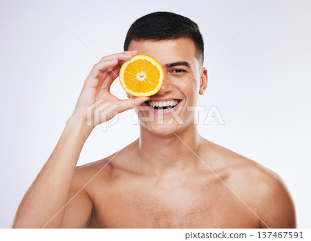 Beauty, orange and smile with portrait of man in studio for health, skincare and natural cosmetics. Vitamin c, nutrition and summer with face of person and fruit on white background for self care 137467591