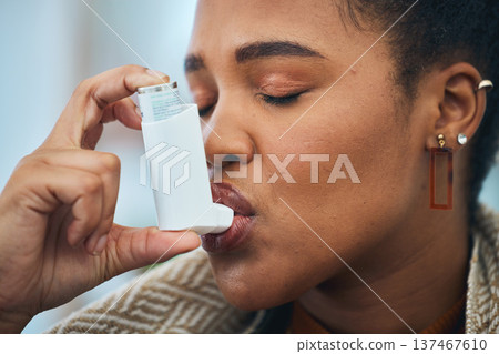 Woman, face and breathe asthma pump for help with health risk, cough treatment and air at home. Closeup, sick african person and spray medicine inhaler for lungs, oxygen or wellness of emergency care Woman, face and breathe asthma pump for help with health risk, cough treatment and air at home. Closeup, sick african person and spray medicine inhaler for lungs, oxygen or wellness of emergency care 137467610