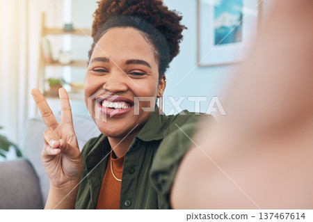 Woman, portrait and peace for selfie in home, smile and post live streaming vlog in living room. Face of happy african gen z, profile picture or show v sign with hand emoji for social media broadcast 137467614
