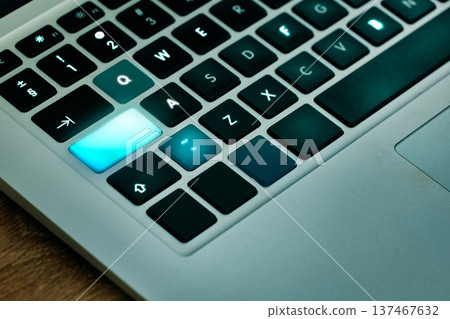 Laptop, keyboard and shift key glow on a desk closeup for networking, typing or blogging in an office. Computer, technology and email connection with futuristic web browsing on a table from above Laptop, keyboard and shift key glow on a desk closeup for networking, typing or blogging in an office. Computer, technology and email connection with futuristic web browsing on a table from above 137467632