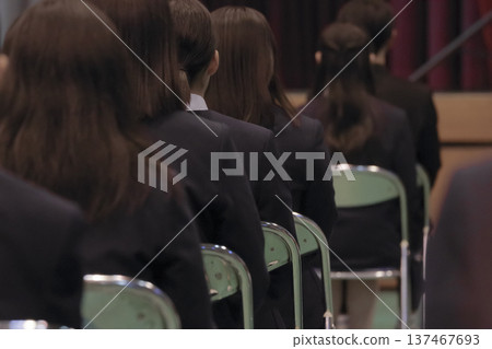 Rear view of participants sitting in chairs at the ceremony venue Rear view of participants sitting in chairs at the ceremony venue 137467693