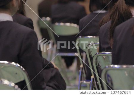 Rear view of participants sitting in chairs at the ceremony venue 137467694