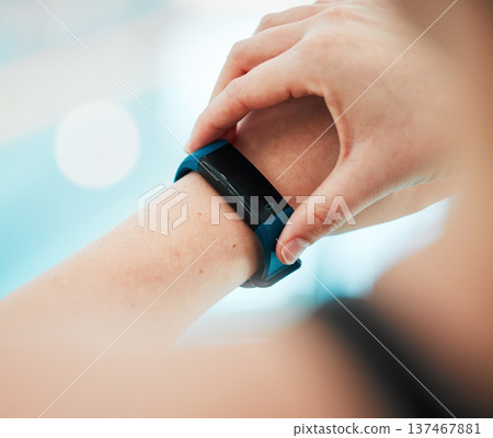 Smartwatch, person or hands of swimmer at swimming pool for sports, workout or fitness progress. Personal trainer, exercise or closeup of athlete with timer to check or monitor heartbeat on app clock Smartwatch, person or hands of swimmer at swimming pool for sports, workout or fitness progress. Personal trainer, exercise or closeup of athlete with timer to check or monitor heartbeat on app clock 137467881