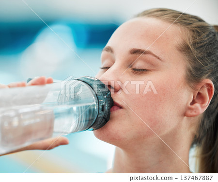 Swimmer woman, drinking water bottle or thinking for fitness, health or wellness for sport career. Athlete girl, hydration and vision by swimming pool at training, exercise or workout for performance Swimmer woman, drinking water bottle or thinking for fitness, health or wellness for sport career. Athlete girl, hydration and vision by swimming pool at training, exercise or workout for performance 137467887