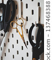 Sewing scissors displayed on a pegboard. Perfect for any crafting enthusiast 137468388
