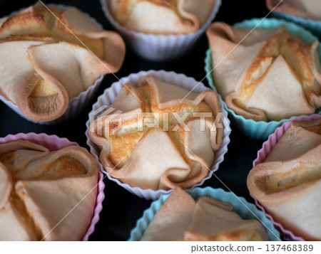 Deliciously baked soffioni pastries in colorful cupcake liners. Perfect sweet treats for special occasions 137468389