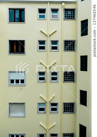 facade of residential yellow building with drainage pipes facade of residential yellow building with drainage pipes 137468546