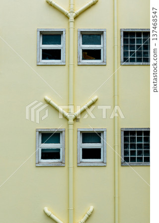 facade of residential yellow building with drainage pipes facade of residential yellow building with drainage pipes 137468547