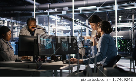 Data center admins working together, collaborating on neural network software development. Teamworking server hub colleagues implementing artificial intelligence technology in workplace, camera A Data center admins working together, collaborating on neural network software development. Teamworking server hub colleagues implementing artificial intelligence technology in workplace, camera A 137469248
